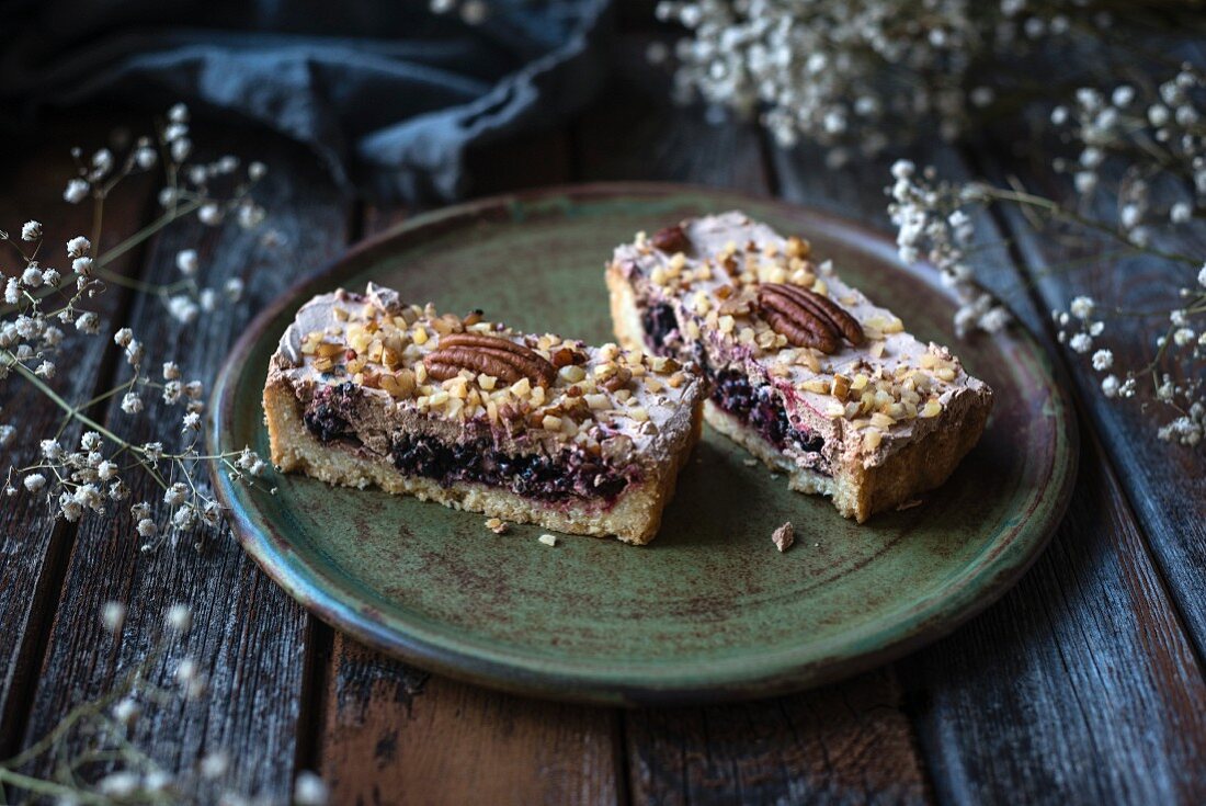 Vegan blackberry cake with chocolate cream and pecan nuts