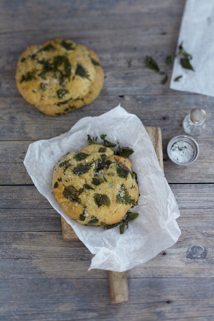 A stinging nettle bread roll on greaseproof paper