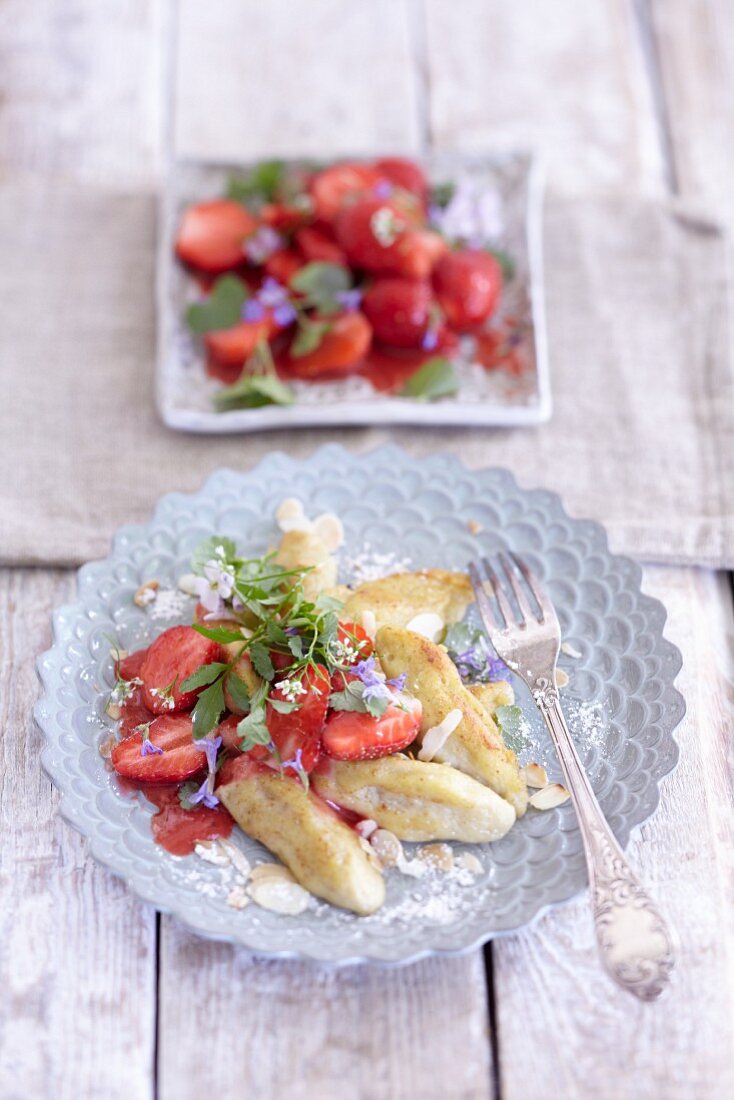 Finger-shaped potato dumplings with strawberry and woodruff salad