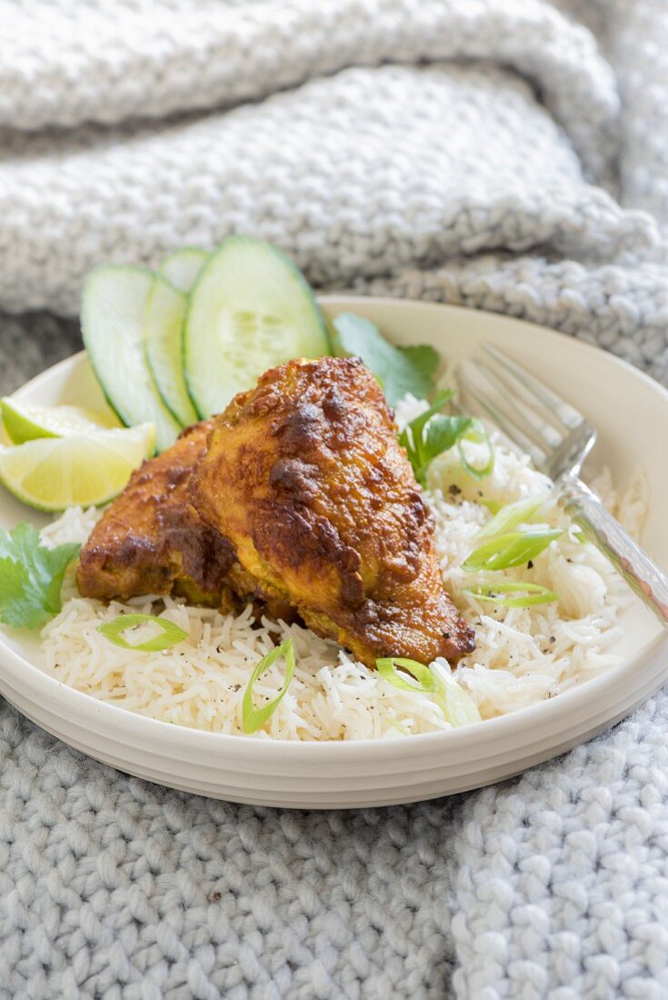 Turmeric chicken on a bed of rice with spring onion