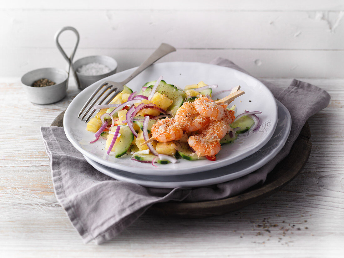 Prawns in a coconut coating with a pineapple and cucumber salad