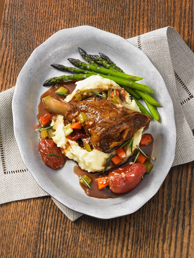 Braised lamb shanks with mashed potato and asparagus