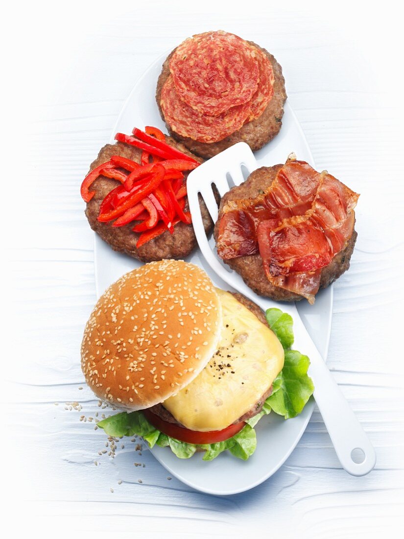 Burger variations with cheese, red pepper, salami and bacon