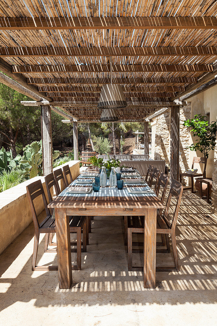 Set dining table and chairs on roofed terrace