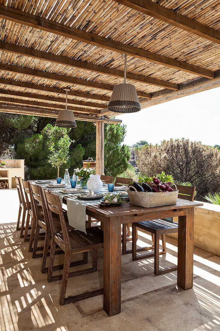 Set dining table and chairs on roofed terrace