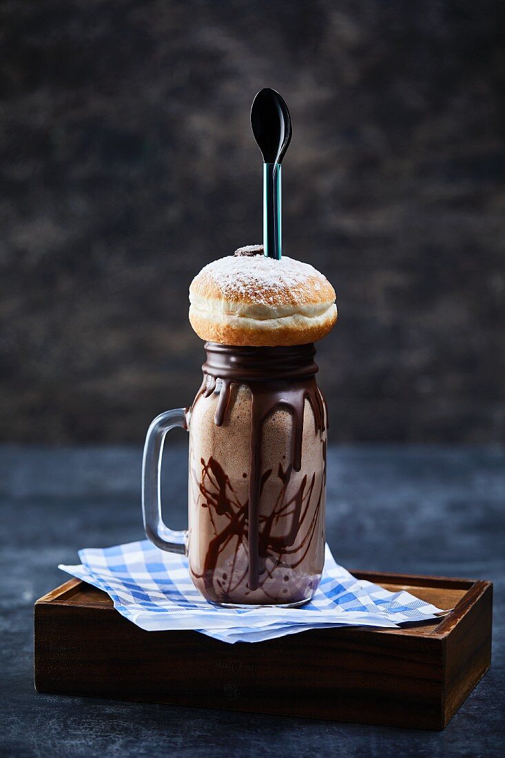 A chocolate freak shake with a doughnut on the top