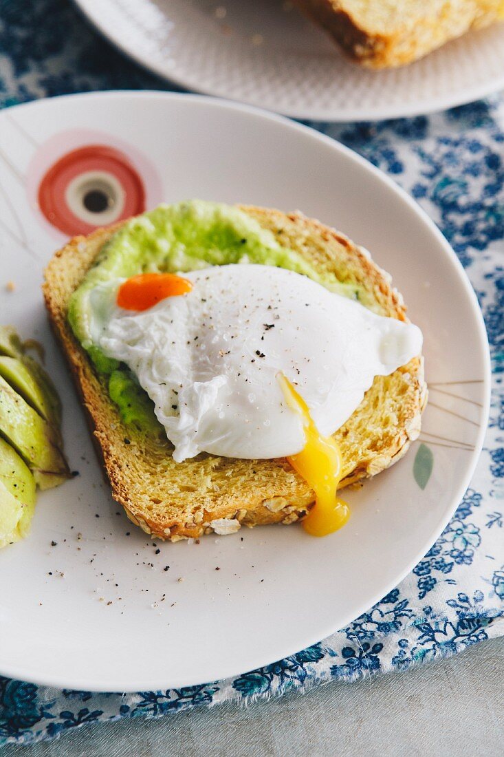 Oat and sweet potato bread topped with avocado and a poached egg