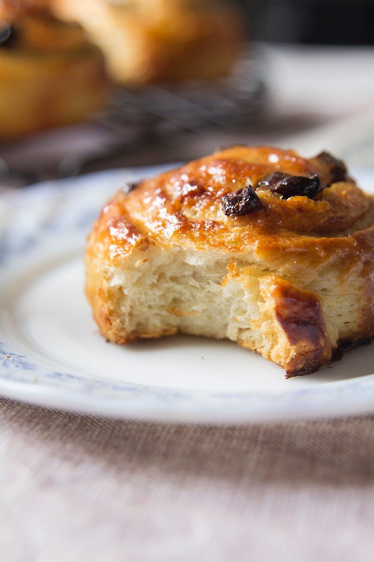 A cinnamon and raisin swirl with a bite out of it