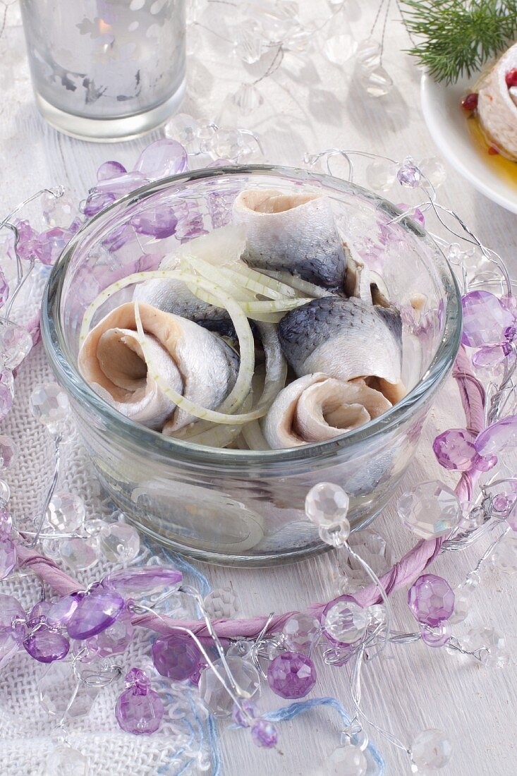 Rollmops (pickled herring fillets) with onion for Christmas