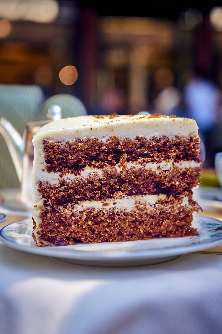 A slice of chocolate cake with buttercream frosting