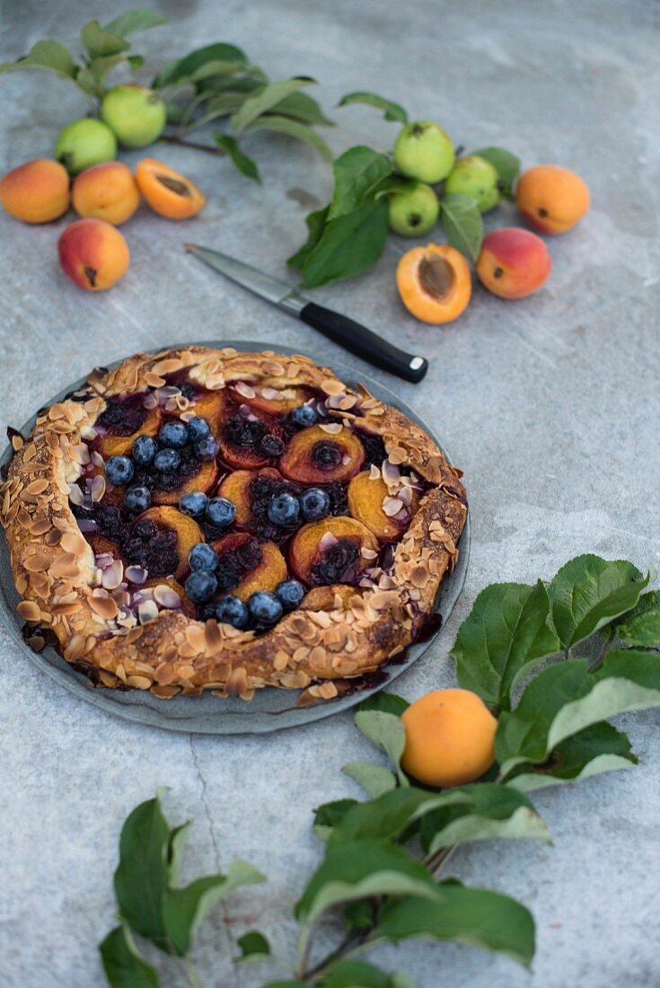 An apricot and blueberry galette with flaked almonds