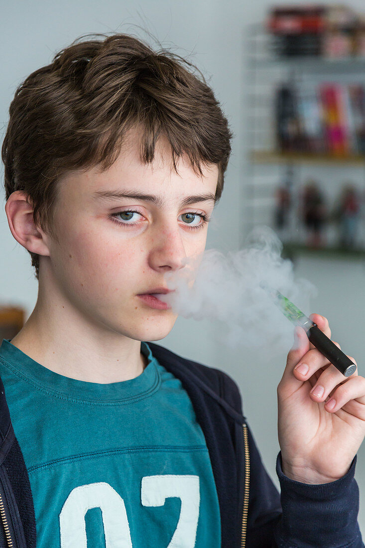 Teenager smoking electronic cigarette
