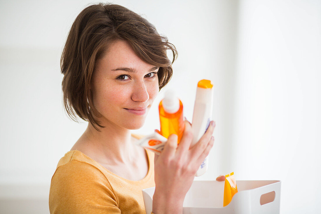 Woman holding different sunscreens