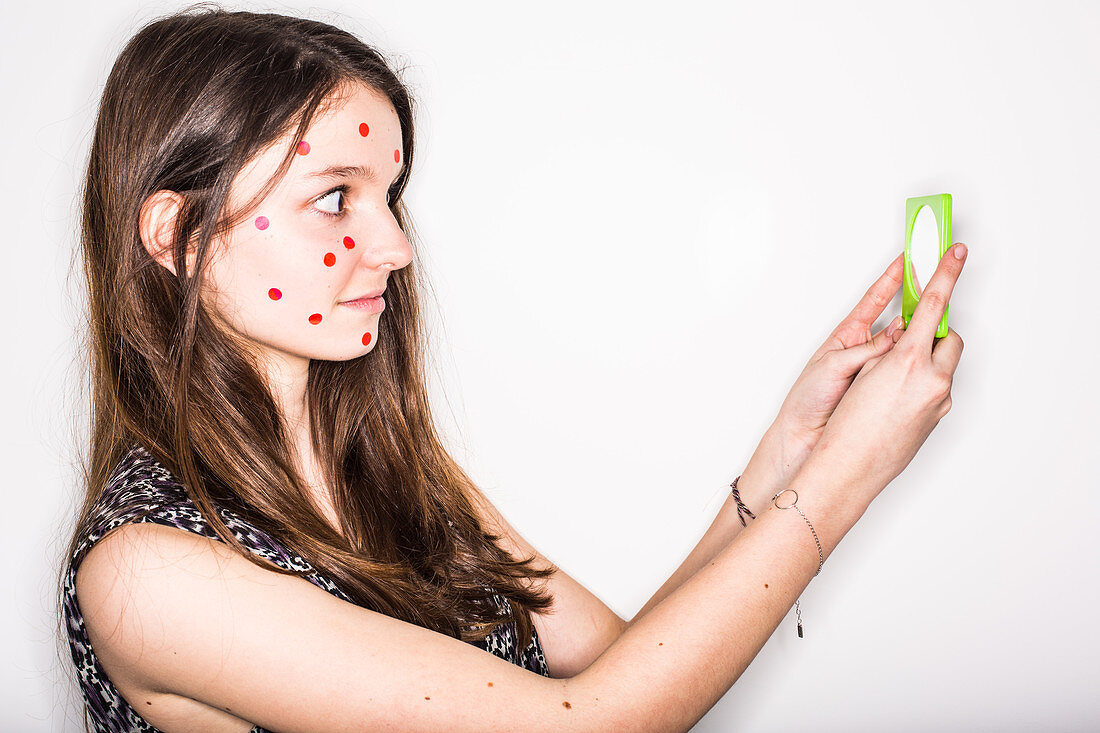 Humorous image of a teenage girl with pimples on the face