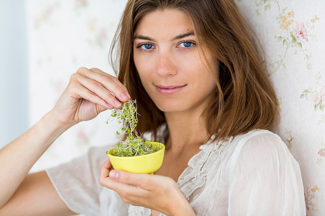 Woman eating sprouts