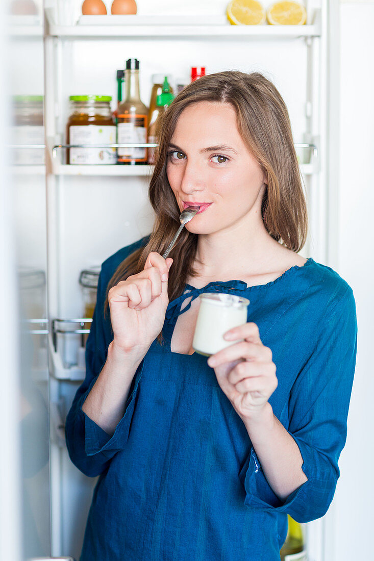 Woman eating a yogurt