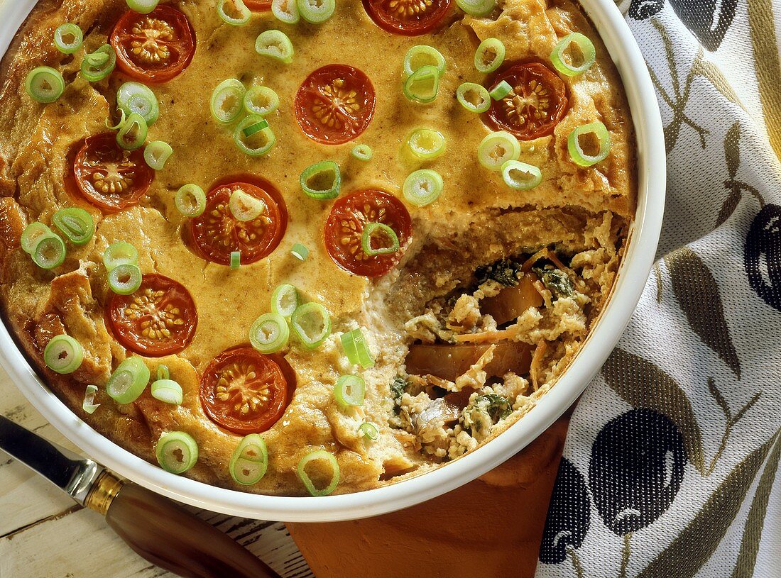 Salted herring & spinach bake with tomatoes & spring onions