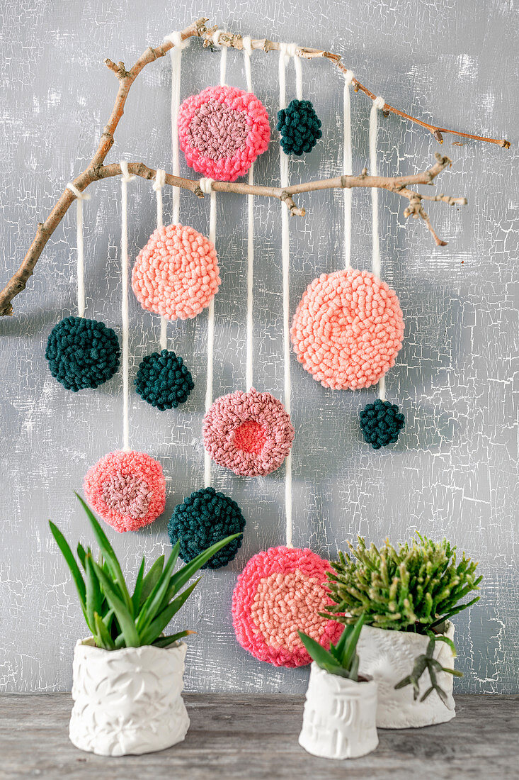 Wall decoration with flowers of various colours made using punch needle technique