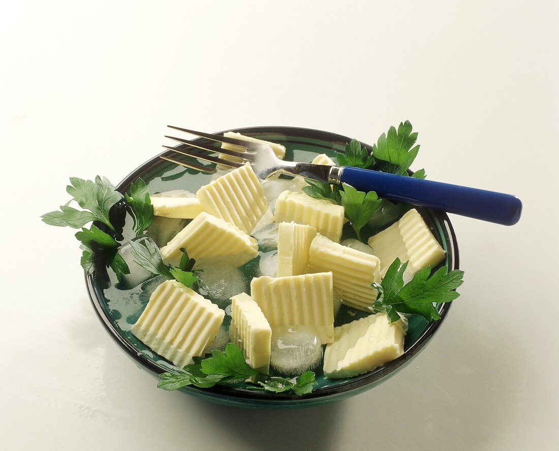 Butter Slices in Ice Water and Parsley
