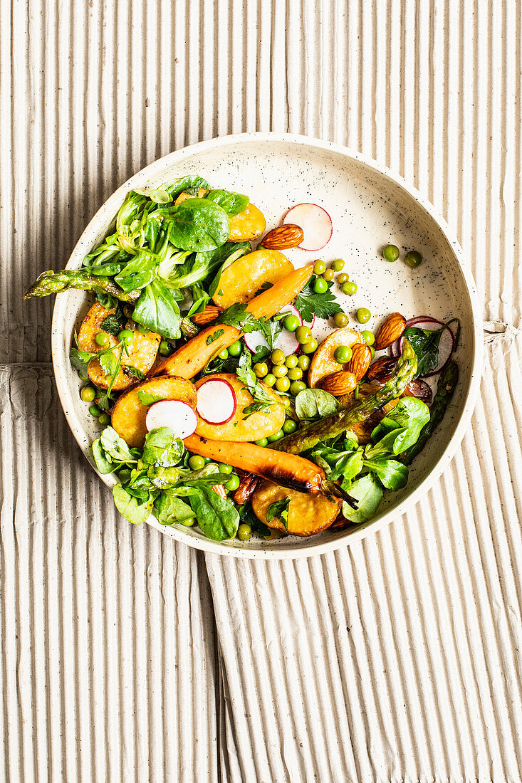 Spring salad with root vegetables, asparagus and peas
