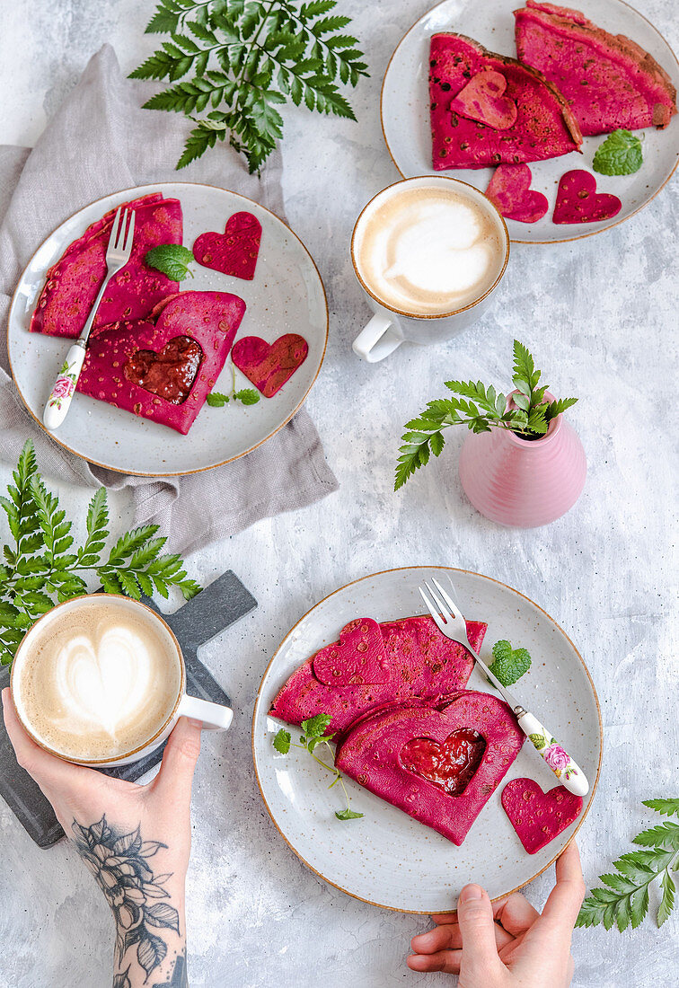 Valentine pink beetroot pancakes with jam, served with coffee