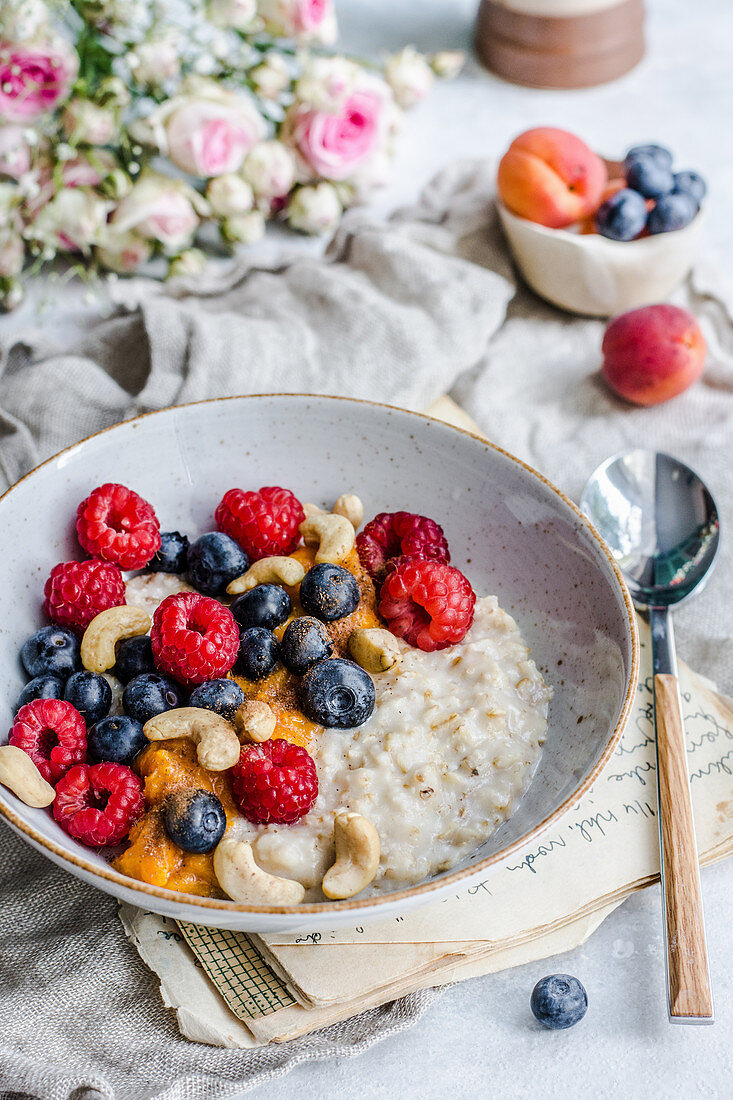 Porridge with summer fruit, blueberries, raspberries and cashews