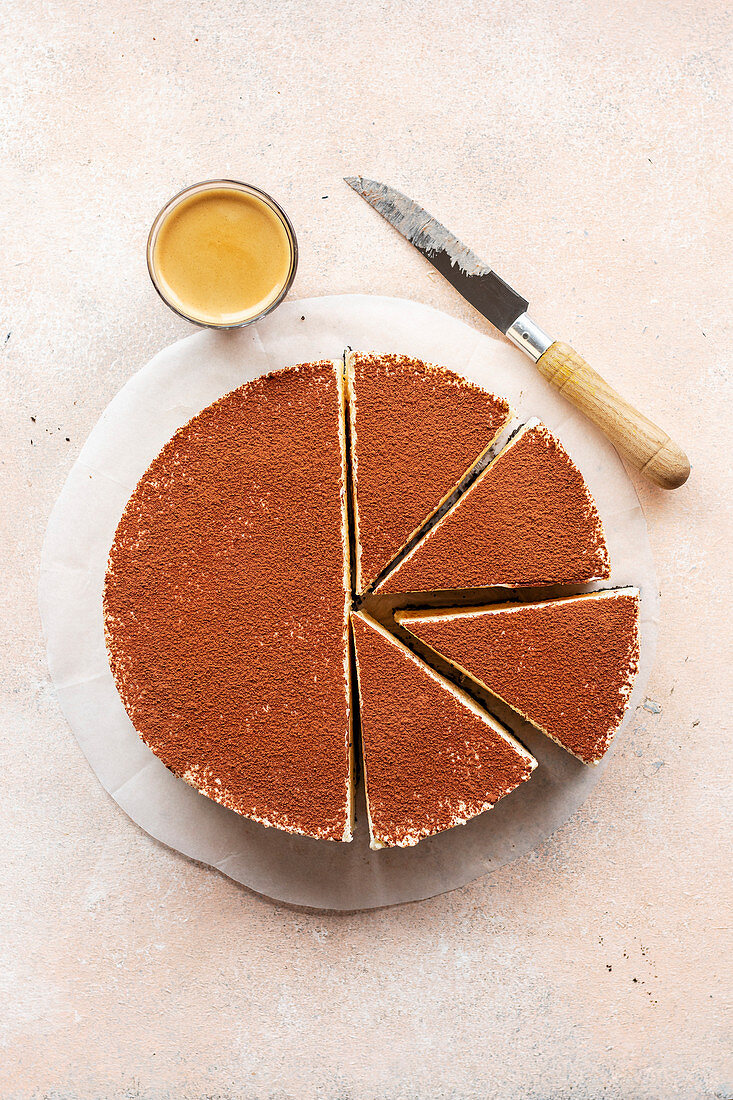 White chocolate cheesecake dusted with cocoa powder on the table