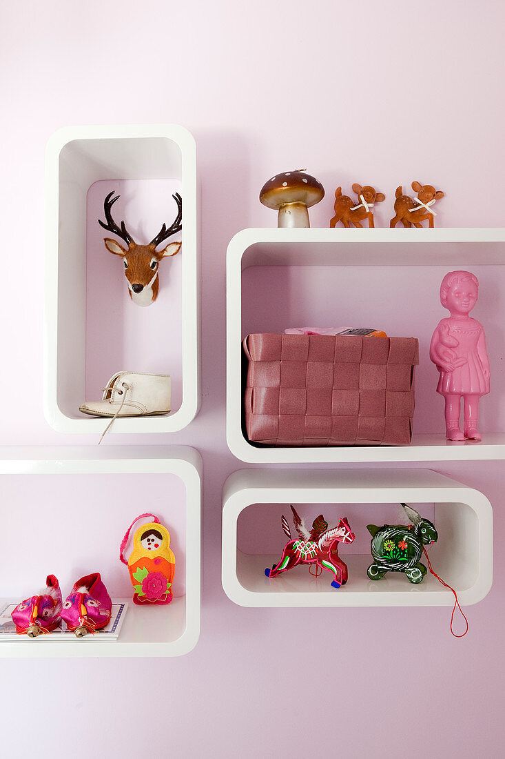 Colourful kitsch accessories in shelving modules with rounded corners