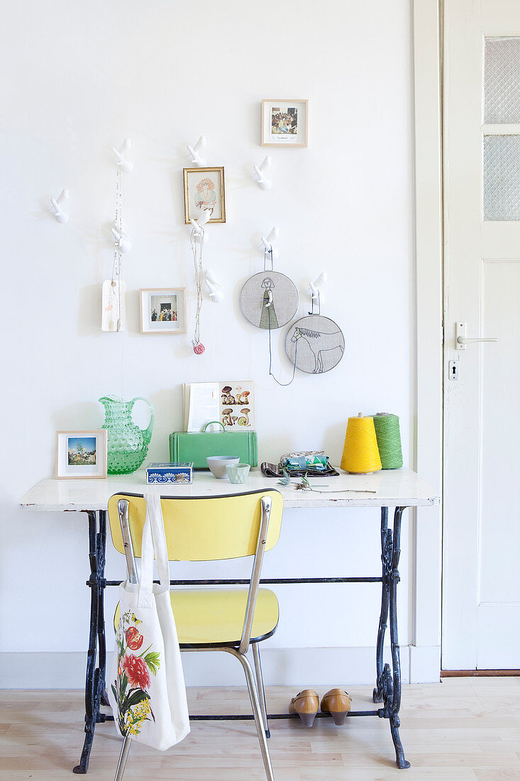 Retro chair on old sewing machine base with yellow and green accessories