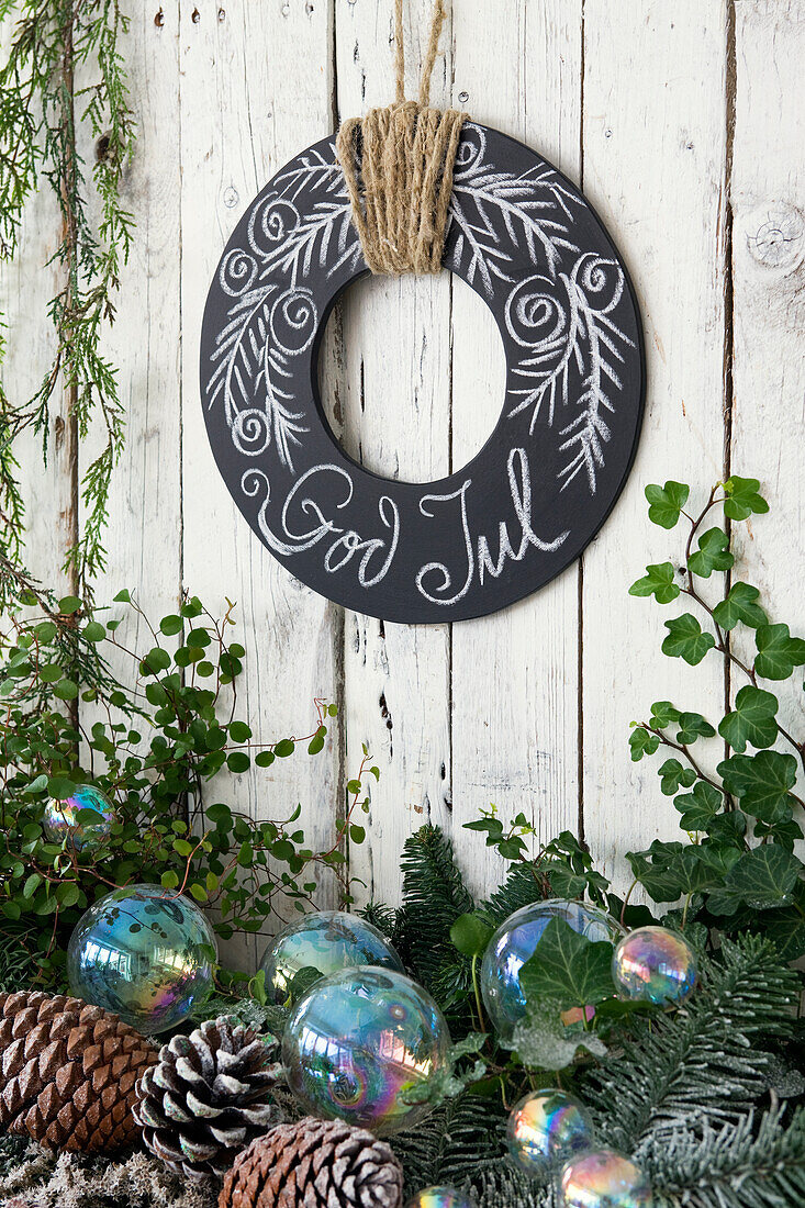 Alternative Advent wreath made of black chalkboard painted wooden board with writing
