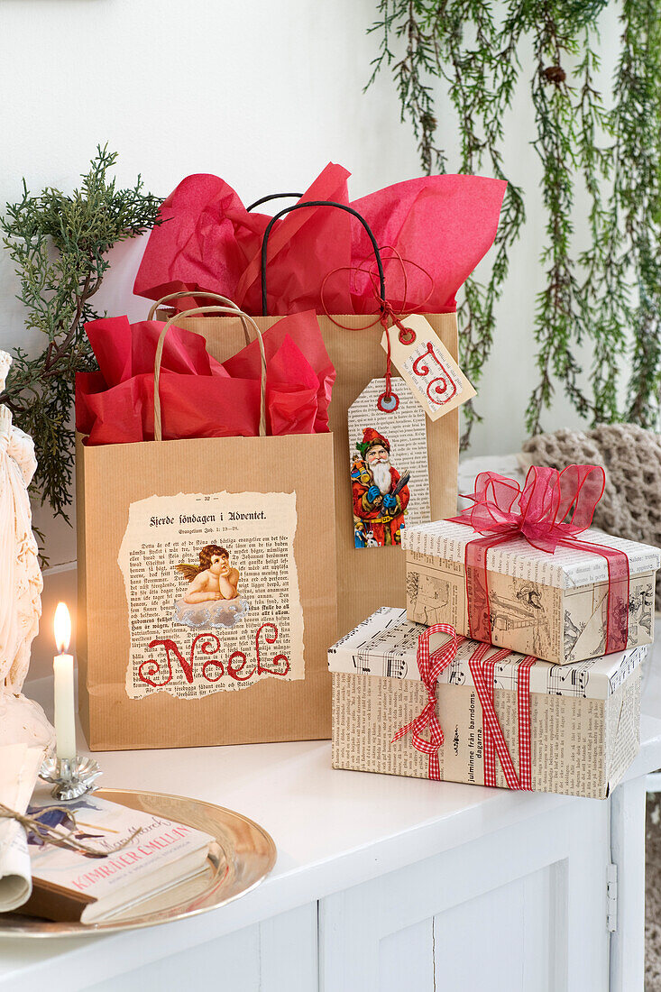 Christmas gift bags and gift boxes decorated with glued on old book pages