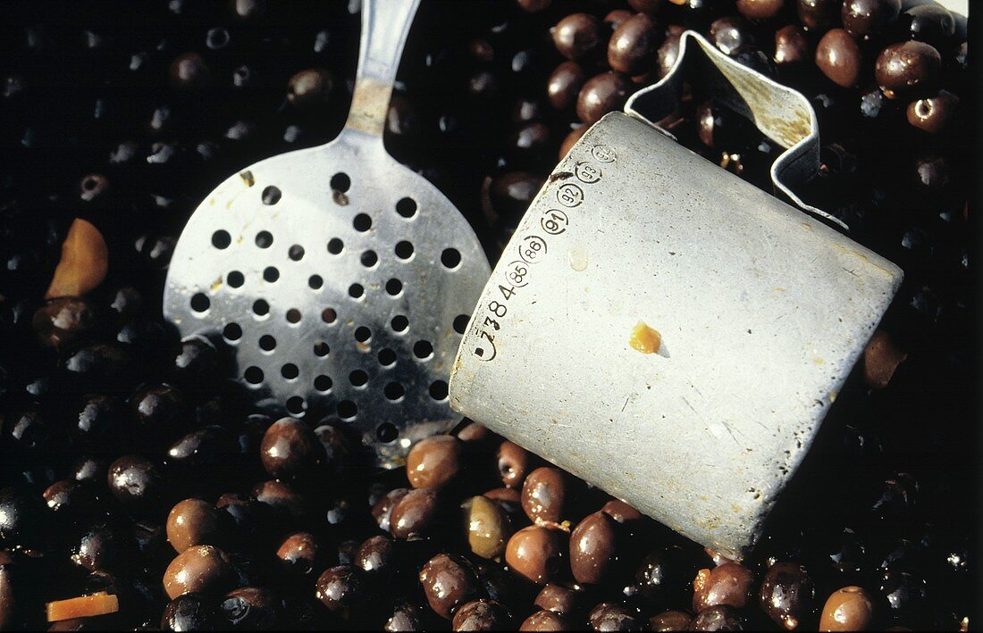 Pickled Olives with a Metal Scoop and Spoon