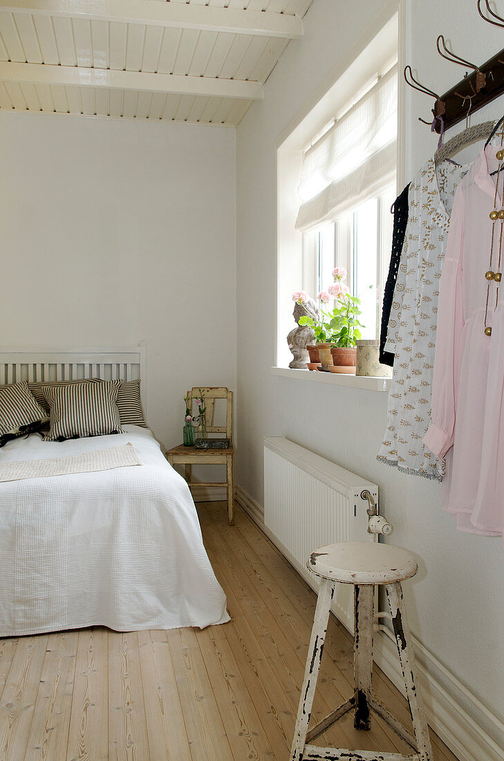 Bedroom in white with wooden floors and shabby chic style