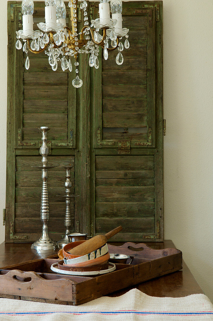 Wooden tray with ceramic bowls in front of an old shutter