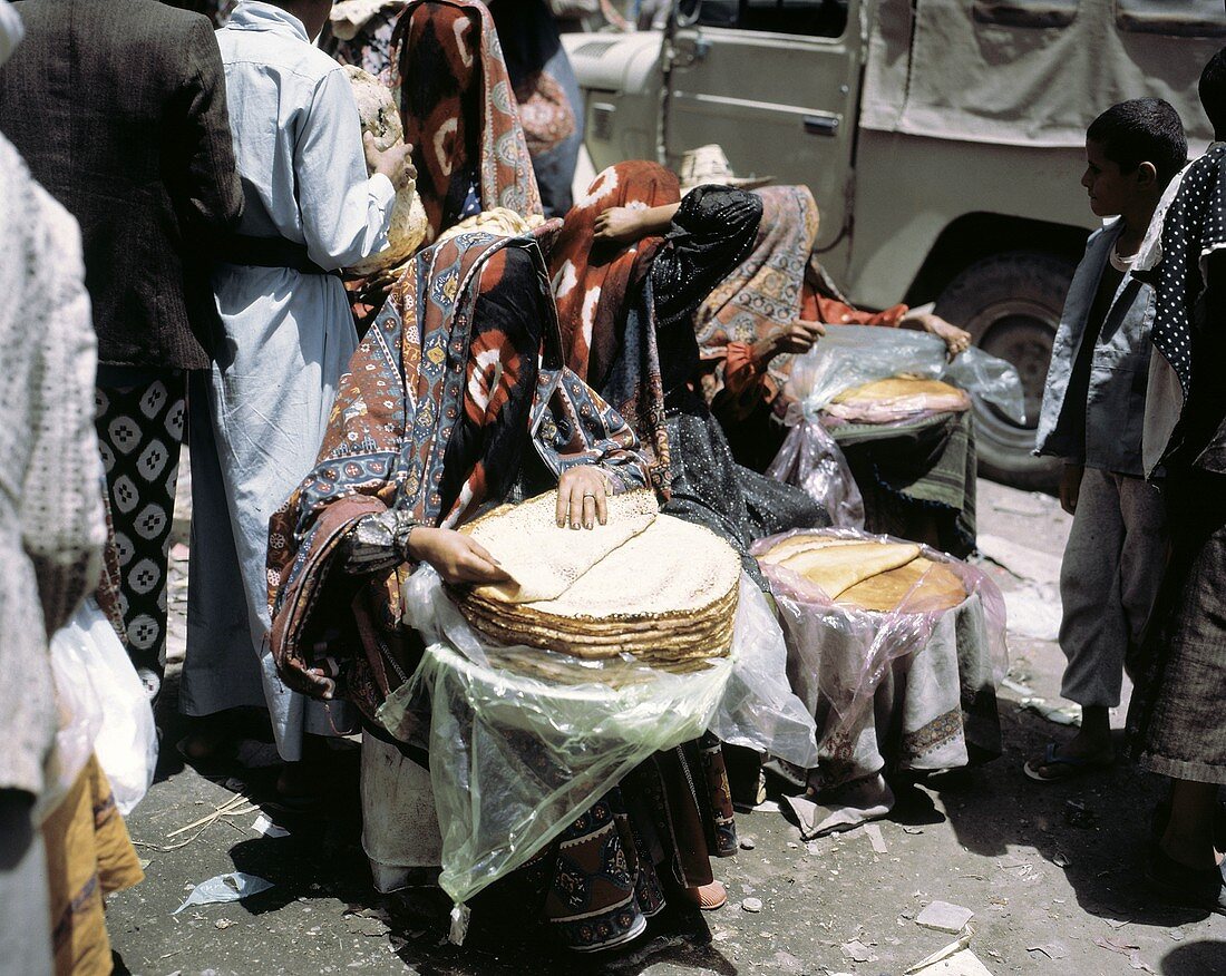 Middle Eastern Woman Selling Flat Bread