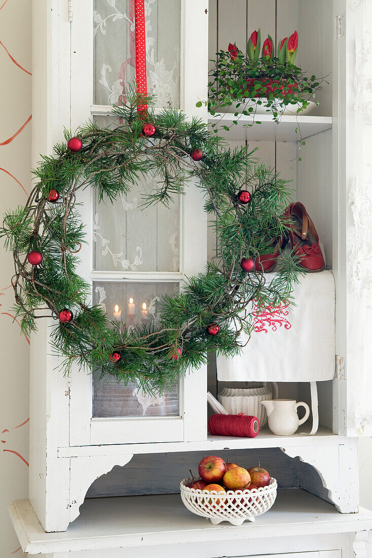 DIY Christmas wreath made of pine branches and red balls