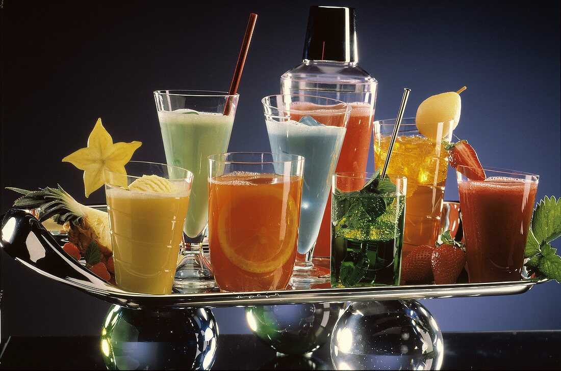 Cocktails with Fruit Garnishes and Juices on Silver Tray