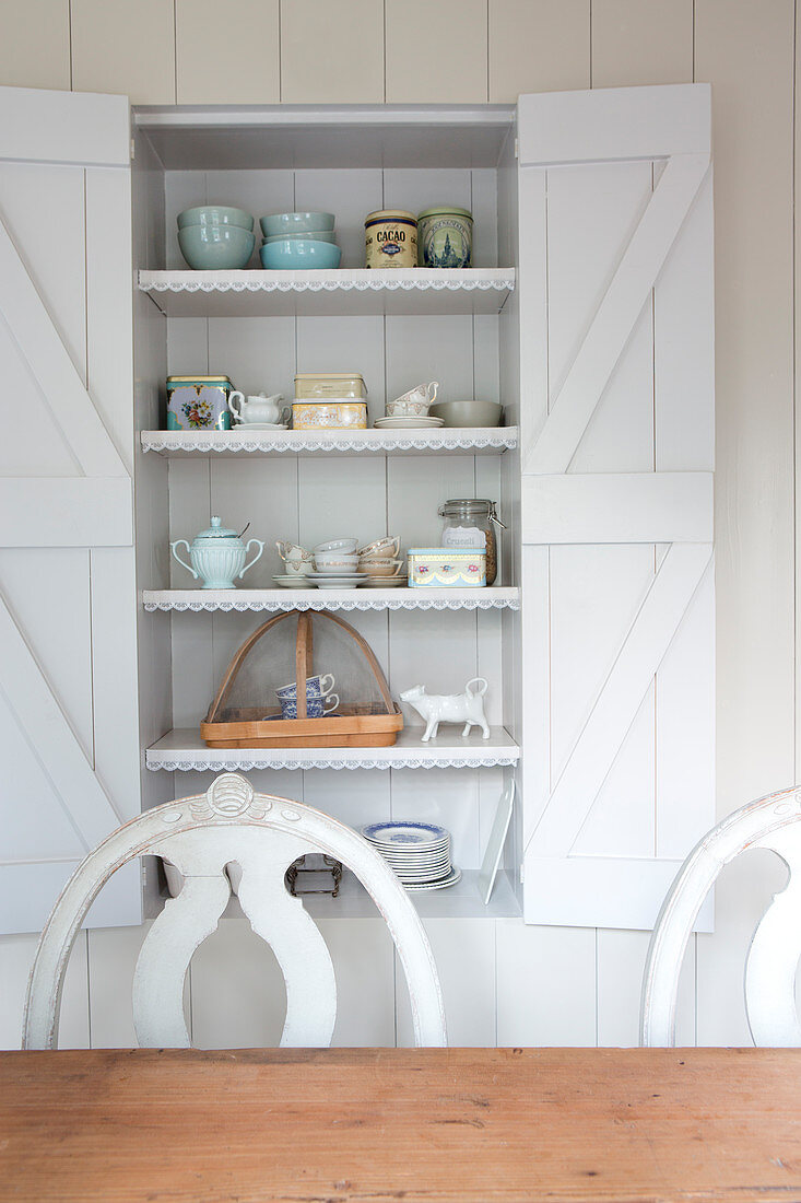 Country cupboardwith barn style shutters and lace trims