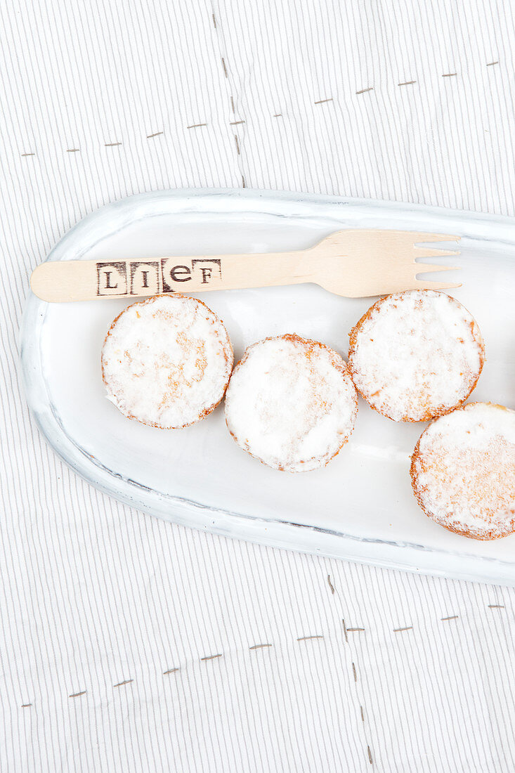 Muffins with powdered sugar on a serving platter