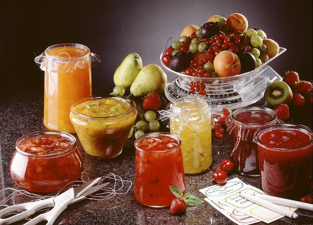 Several jams and preserves and fresh fruit on scales