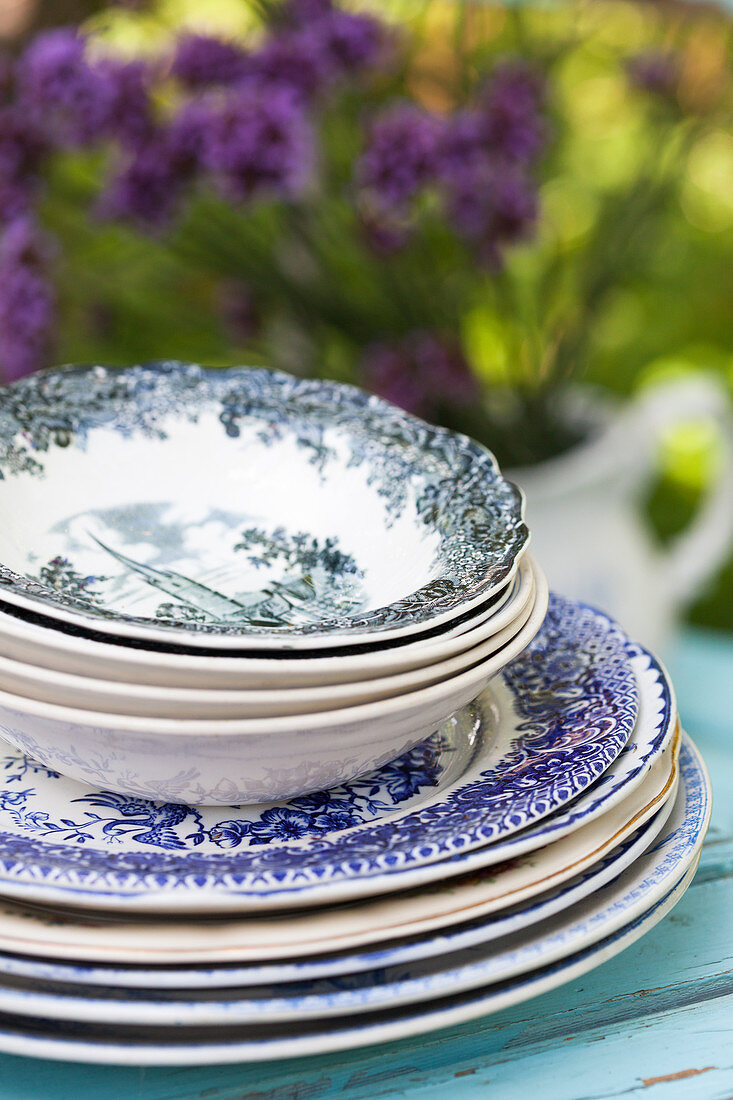 Stack of old plates and bowls with classic pattern