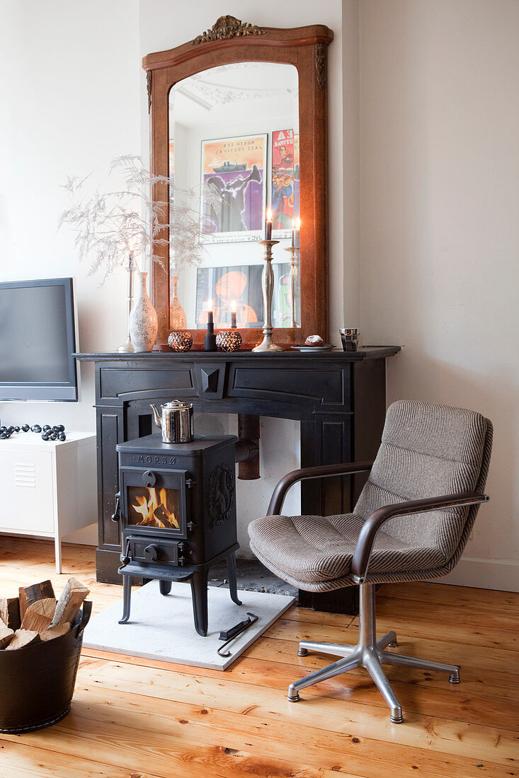 Retro swivel chair in front of a small stove in the fireplace