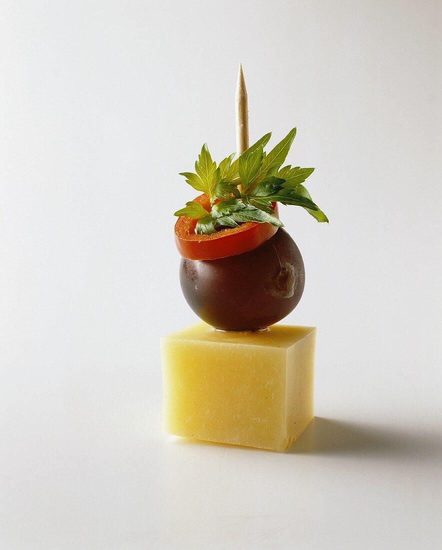 Cheese kebab with grape, chili ring and parsley