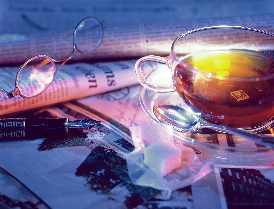 Cup of Hot Tea with Newspaper; Sugar Cube