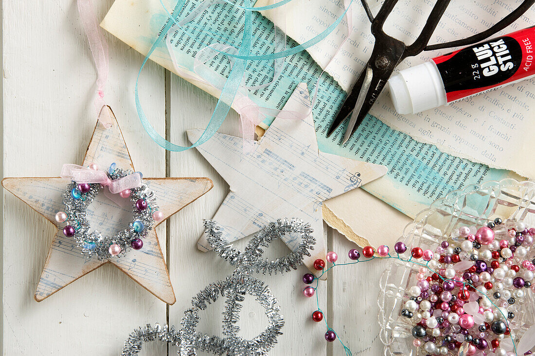 Handmade nostalgic star ornaments made out of paper, ribbons, and beads