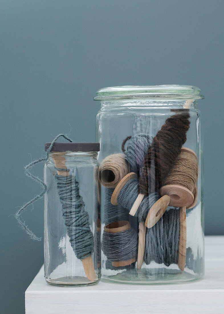 Cords on spools of thread in screw jar and mason jar