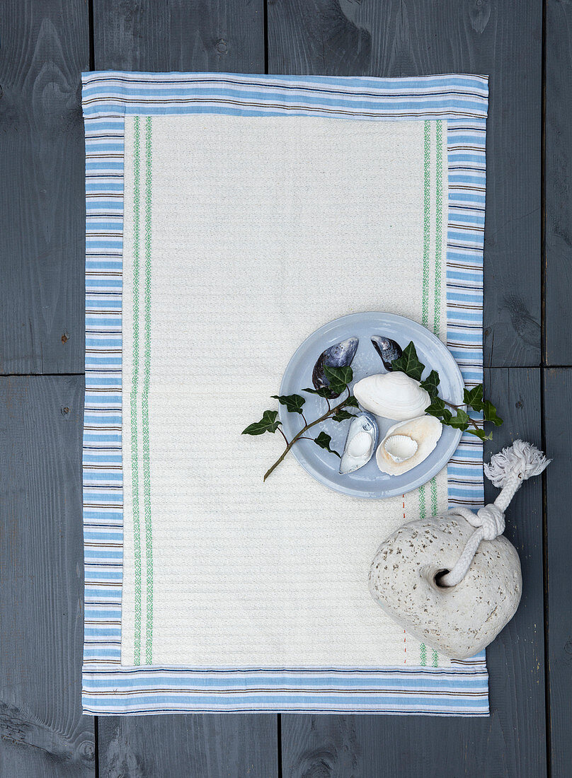 Homemade bath mat made from tea towels and striped fabric