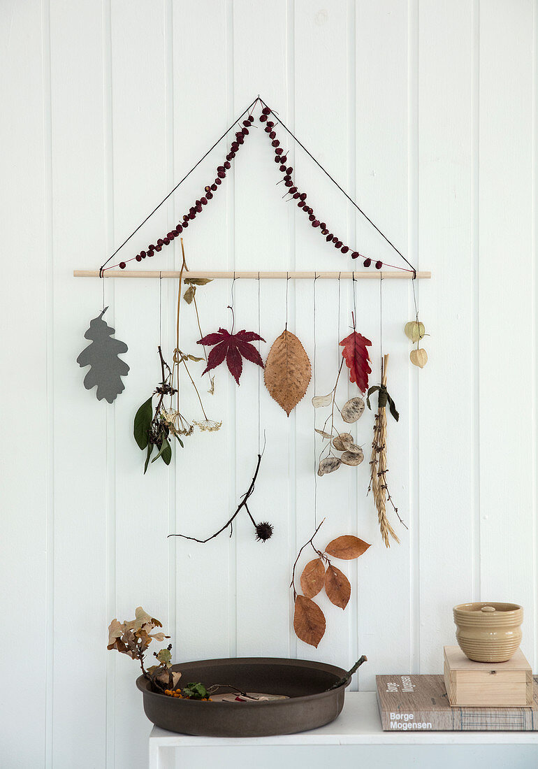 A DIY mobile made from autumnal objects