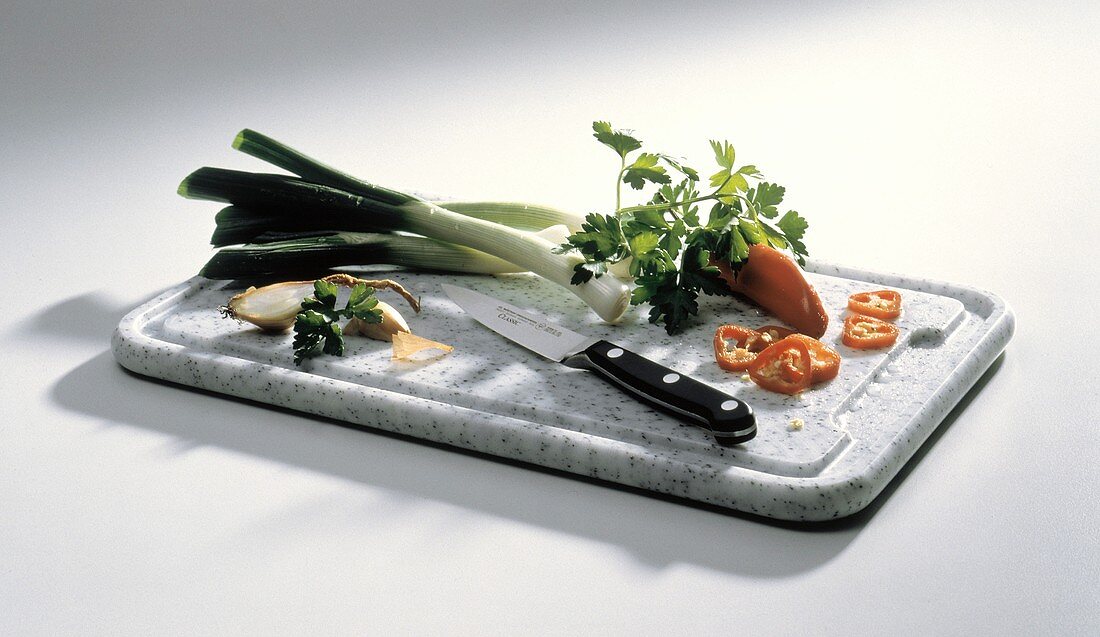 Assorted Vegetables on a Cutting Board; Knife