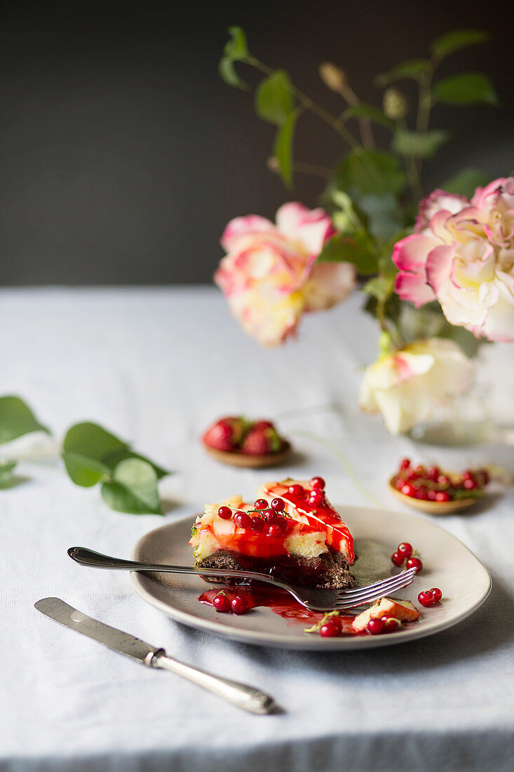 Two slices of cheesecake with redcurrants on a table